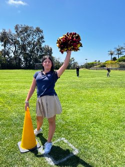 student posing with pom pom